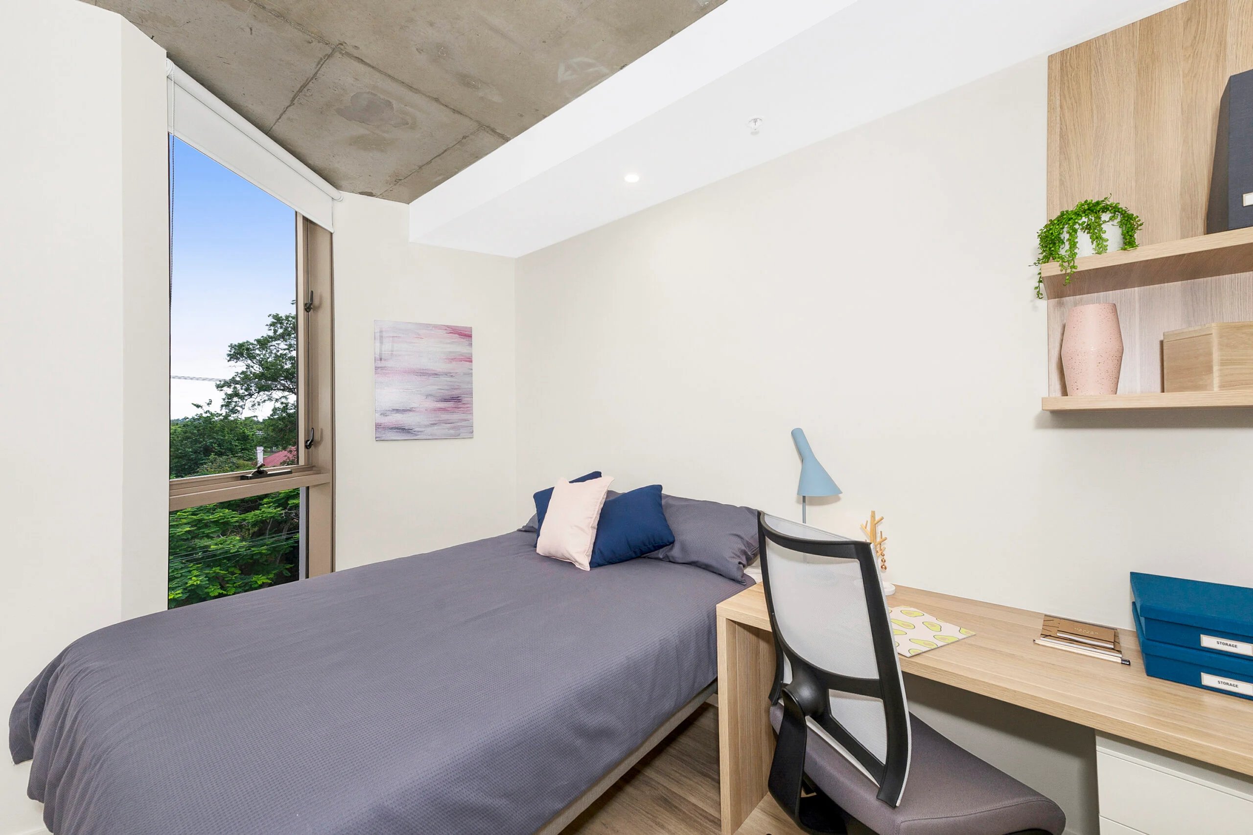 Bed desk chair artwork window and shelf Bedroom at Scape St Lucia in Brisbane Student Accommodation