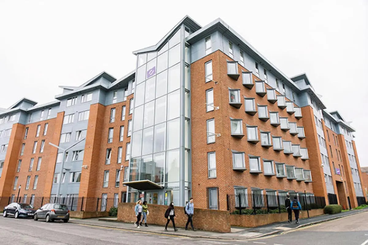 Modern brick building with many windows exterior at Queen's Park House in Coventry Student Accommodation