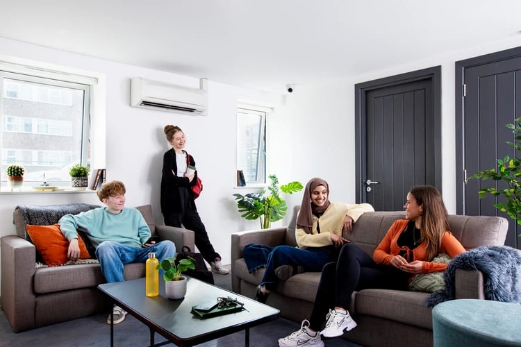 Students relaxing on sofas in common room living area at Castle Court in Leicester Student Accommodation
