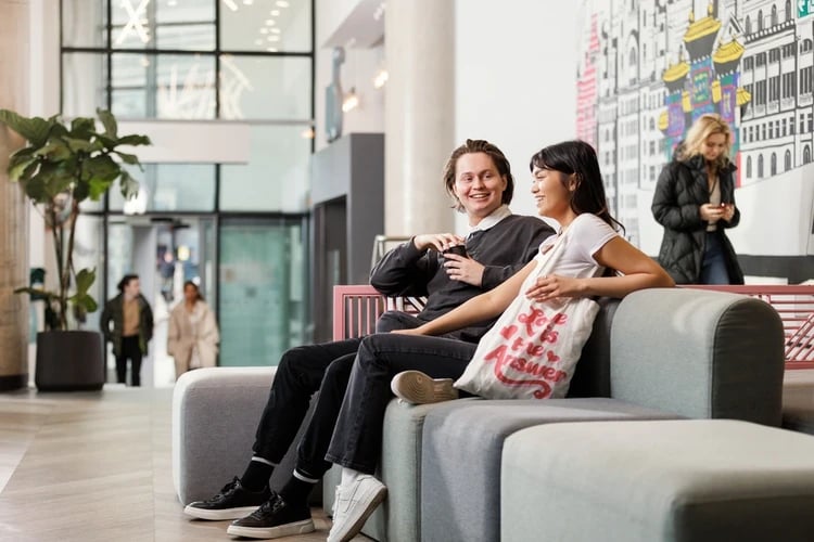 Sofa seating with students and art decor common area at Horizon Heights in Liverpool Student Accommodation