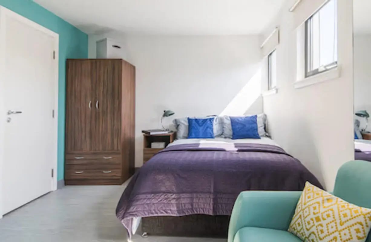 Bed wardrobe nightstand couch bedroom at Claremont House in Glasgow Student Accommodation