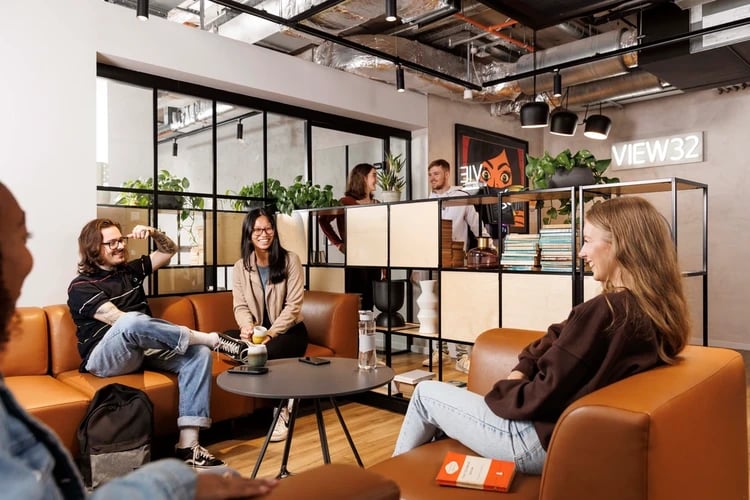 People sitting on sofas in lounge area living room at Artisan Heights in Manchester Student Accommodation