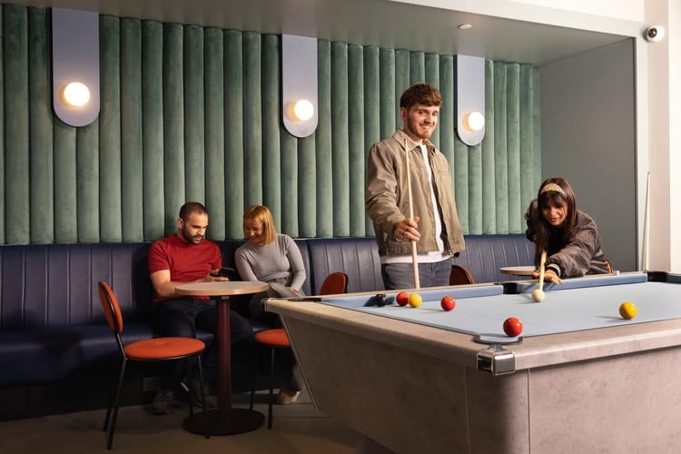 People playing billiards and sitting lounge area playing area at Bromley Place in Nottingham Student Accommodation