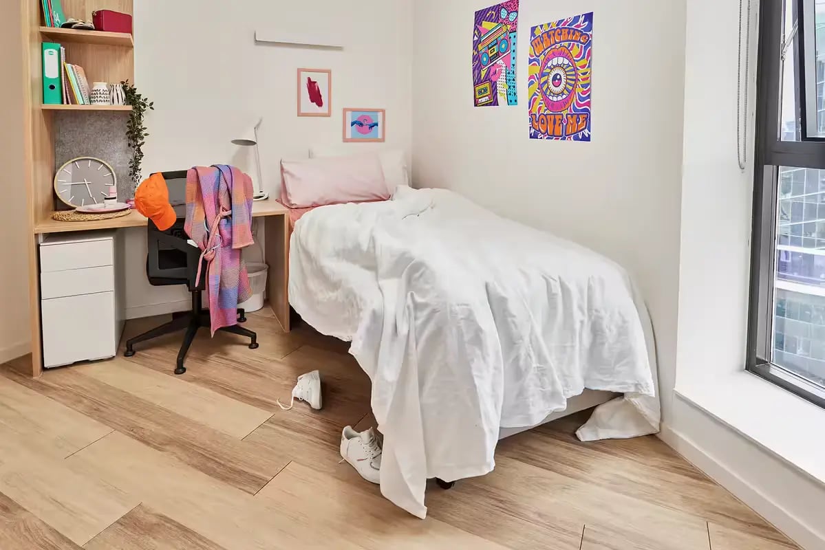 Bed desk chair and posters bedroom at Scape Peel in Melbourne Student Accommodation
