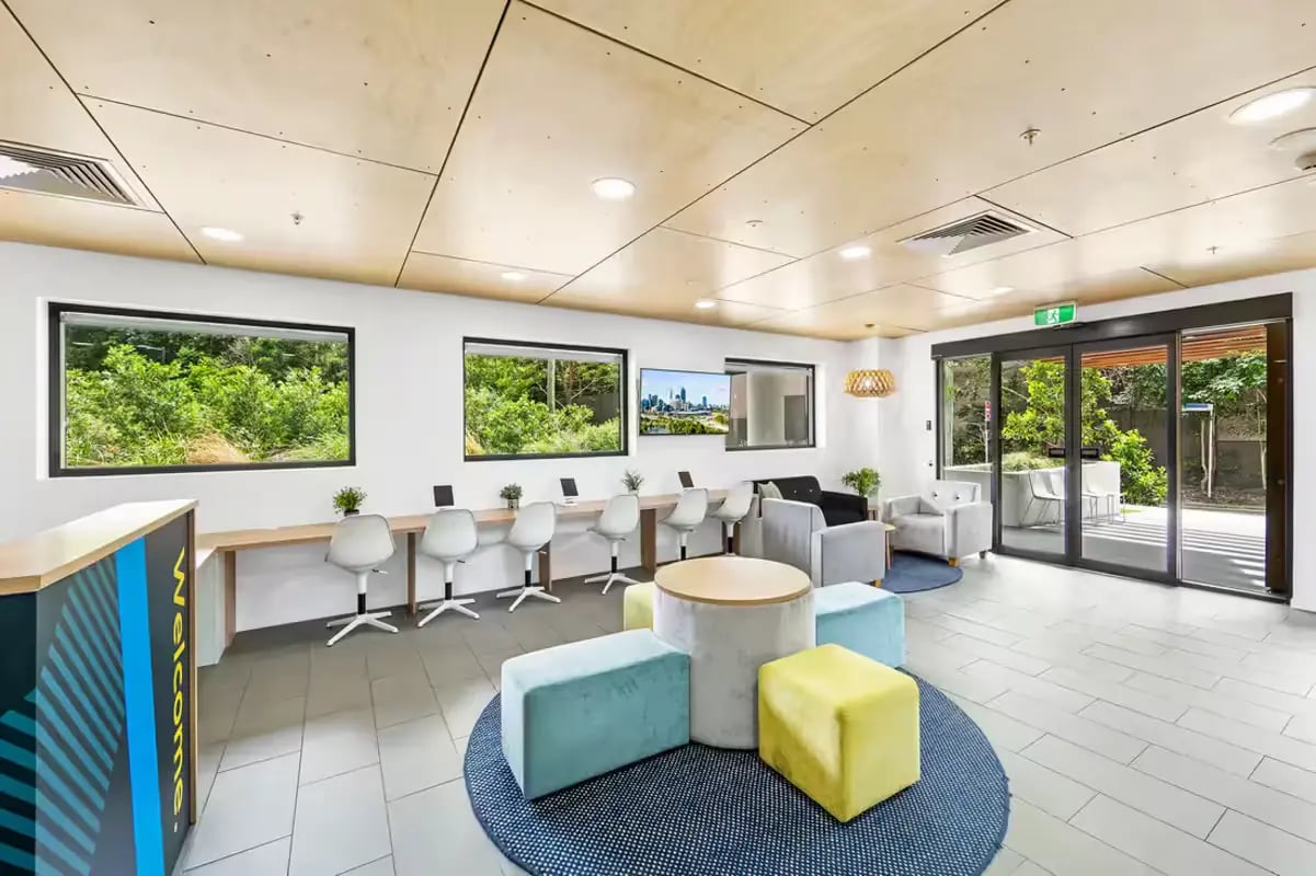 Study area with desks, chairs, and lounge seating. at Scape Regent in Brisbane Student Accommodation