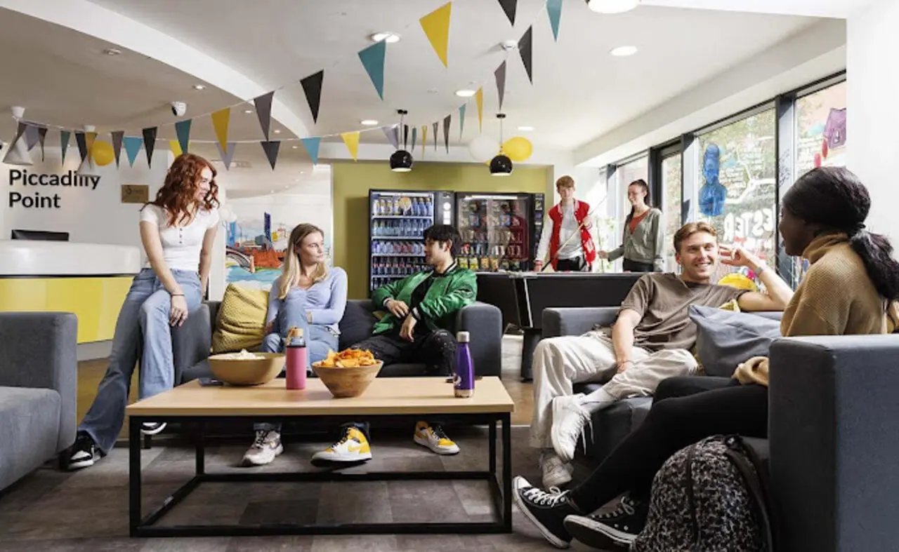 Students relaxing chatting vending machines common room at Piccadilly Point in Manchester Student Accommodation