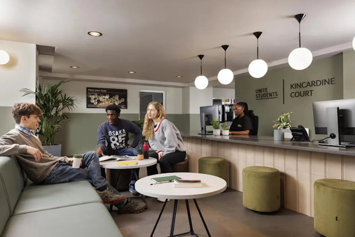 Students lounge seating reception desk area common room at Kincardine Court in Manchester Student Accommodation