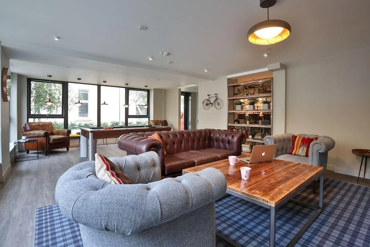 Chesterfield sofas pool table leather chairs living room at The Ballet School in Glasgow Student Accommodation
