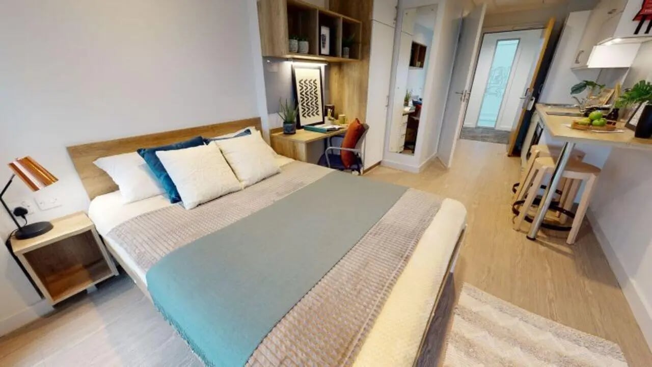 Bed desk shelves and kitchen area living room at iQ Elgin Place in Glasgow Student Accommodation