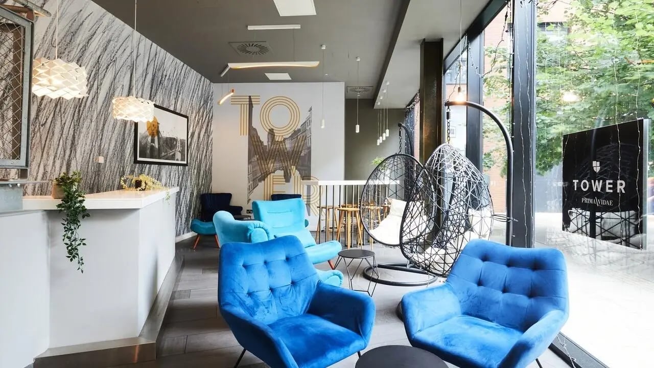 Blue armchairs and hanging chairs communal area at Collegiate Tower in Bristol Student Accommodation