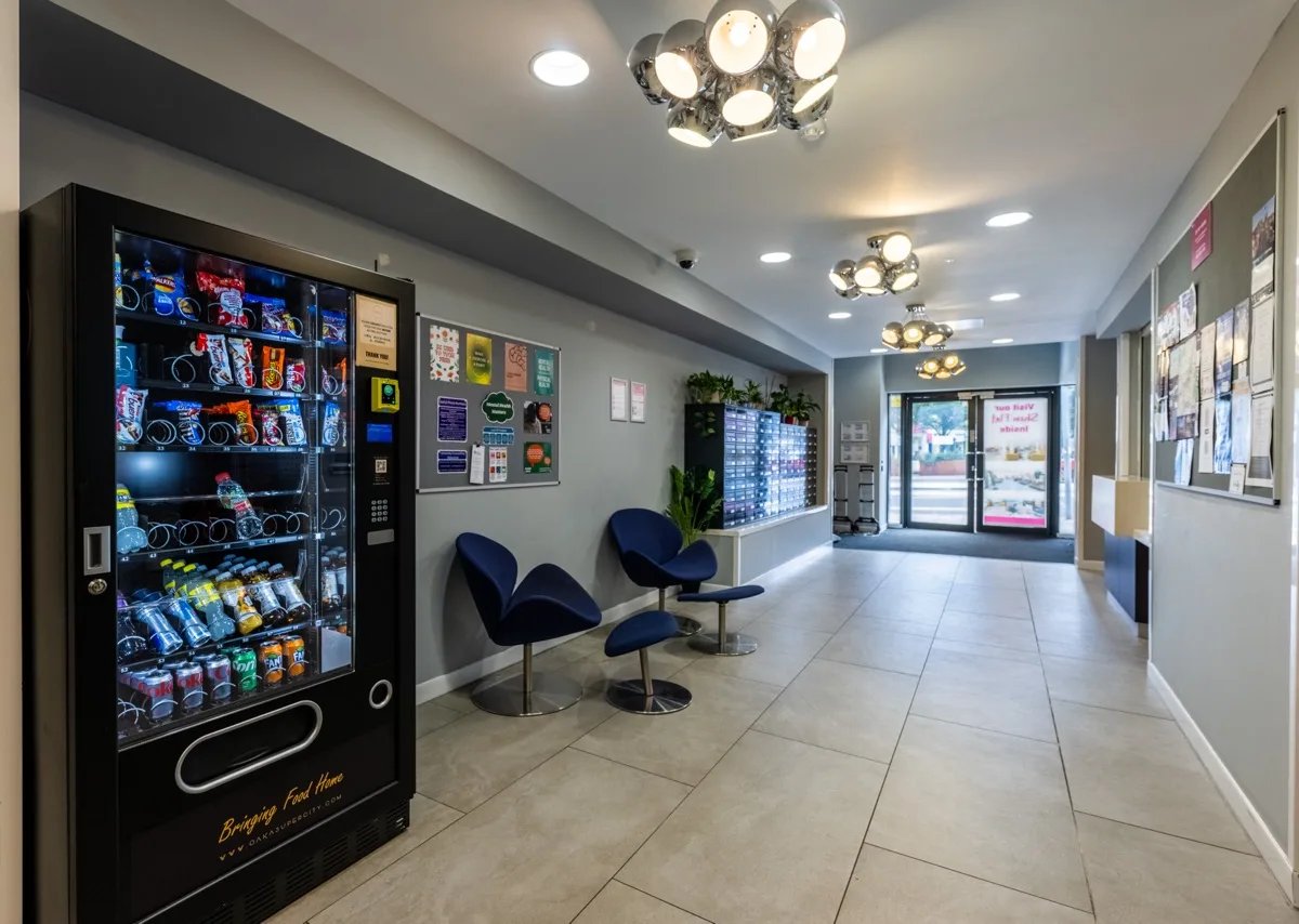 Vending machine chairs lockers and noticeboard hallway at Haddington Place in Edinburgh Student Accommodation