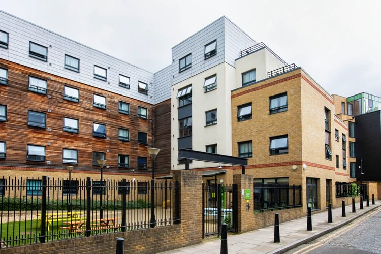 Modern student accommodation building with brick and wood exterior exterior at Pacific Court in London Student Accommodation