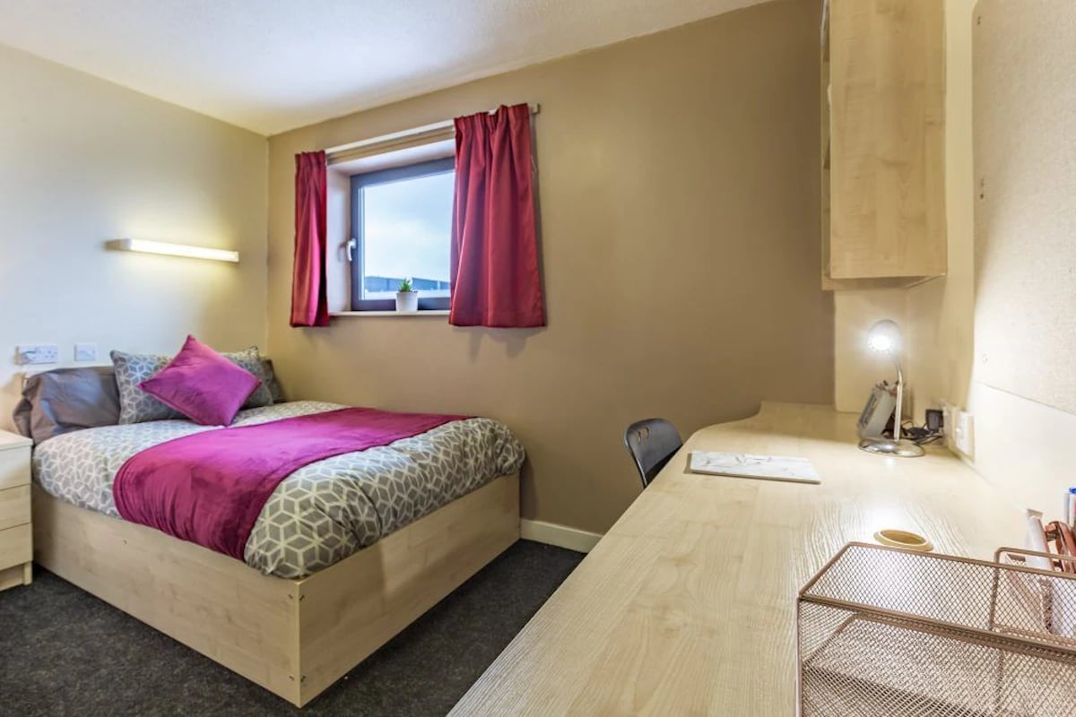 Bed desk and chair in room bedroom at The Pinnacles in Sheffield Student Accommodation