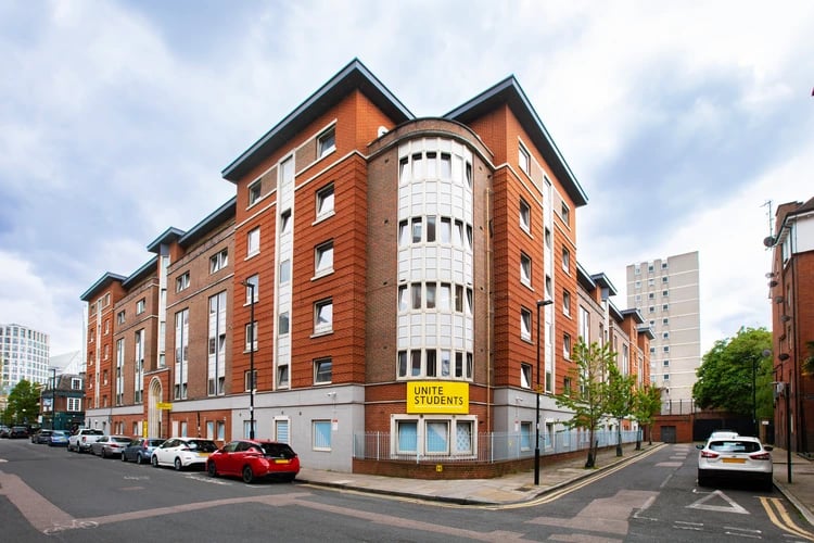 Brick student accommodation with cars outside exterior at East Central House in London Student Accommodation