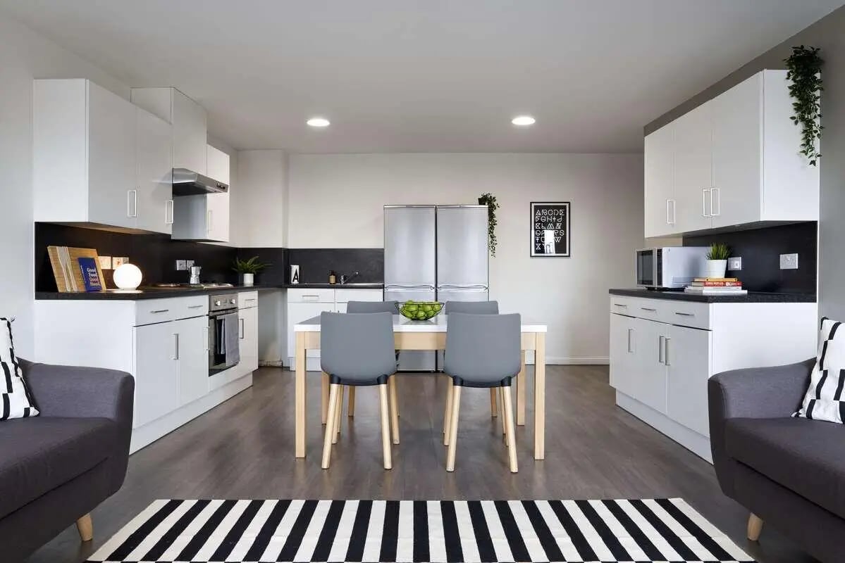Modern kitchen with dining area and sofas Kitchen at Sharman Court in Sheffield Student Accommodation