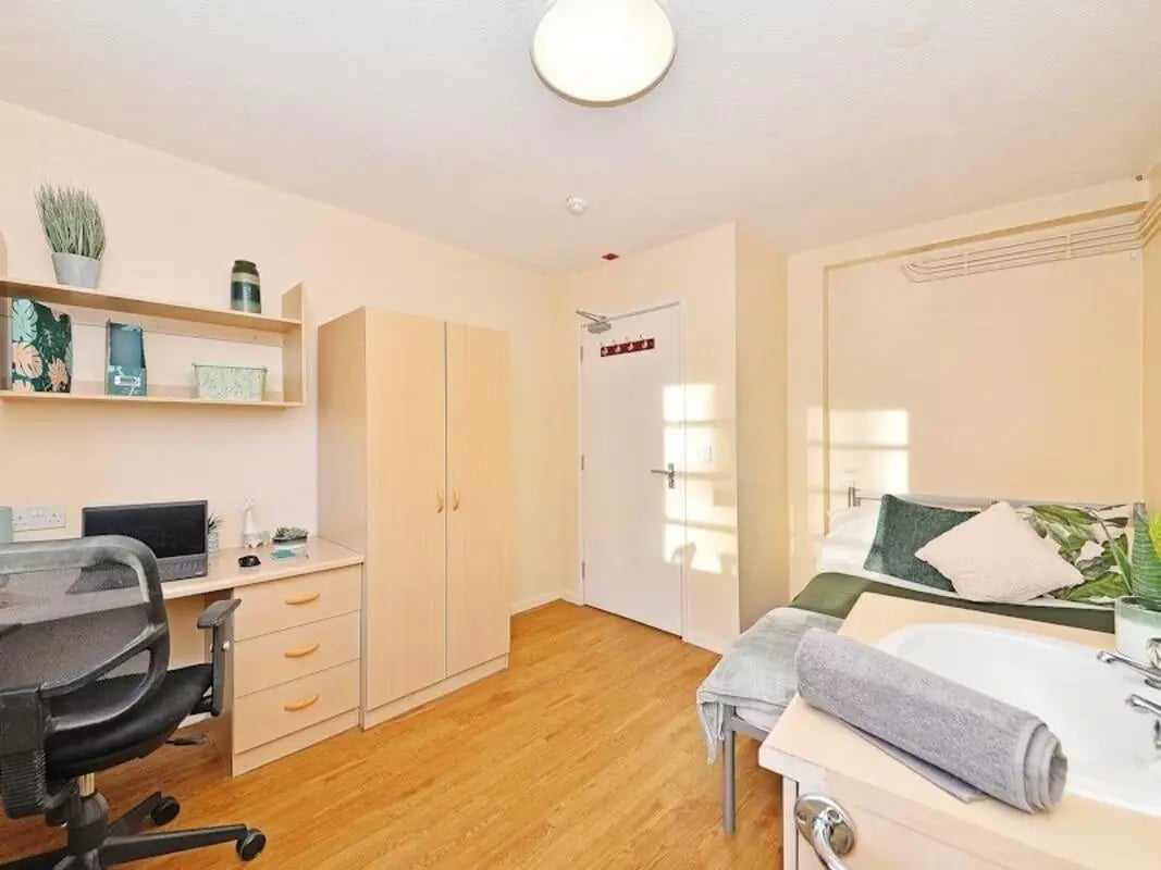 Desk chair wardrobe and bed bedroom at St Andrews Gardens - Liverpool in Liverpool Student Accommodation
