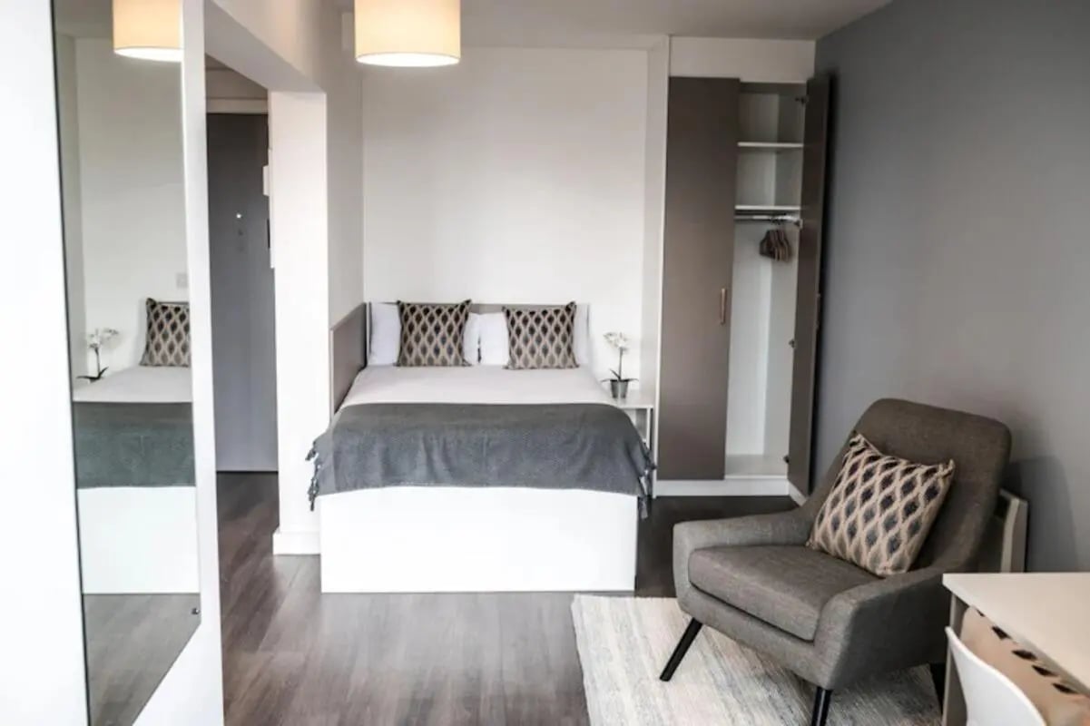 Bed wardrobe armchair and mirror bedroom at McDonald Road in Edinburgh Student Accommodation