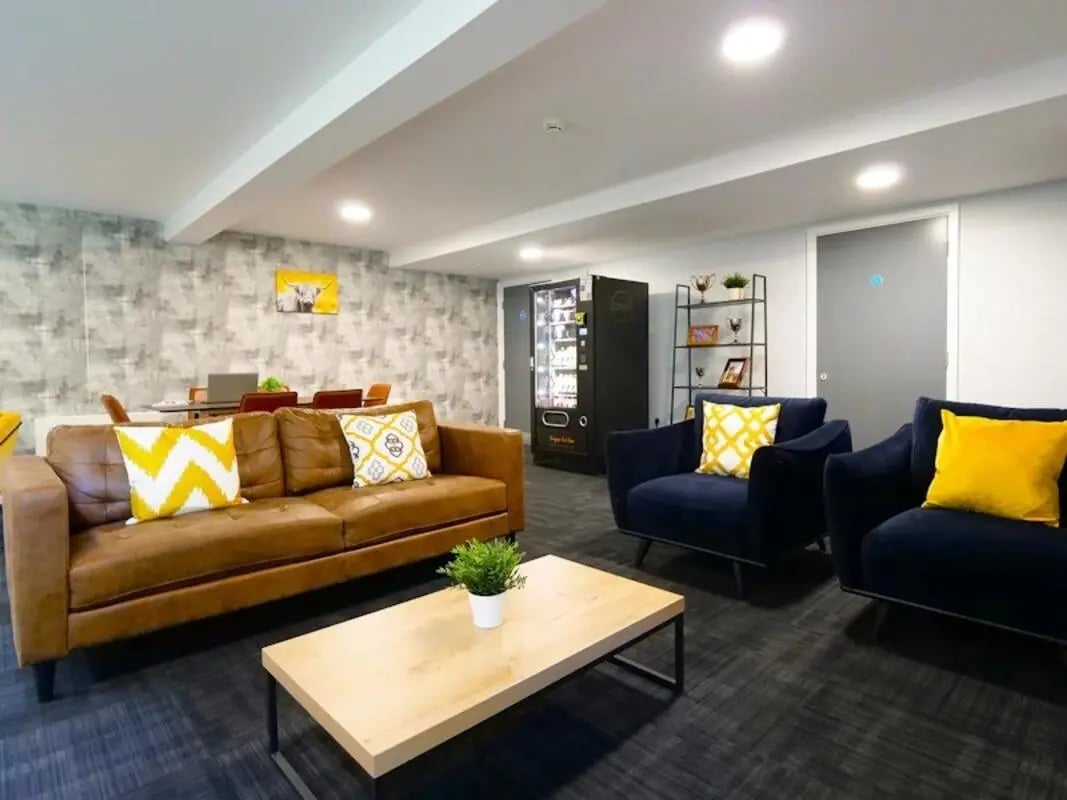 Leather sofa vending machine blue chairs living room at Gateway Apartments in Edinburgh Student Accommodation