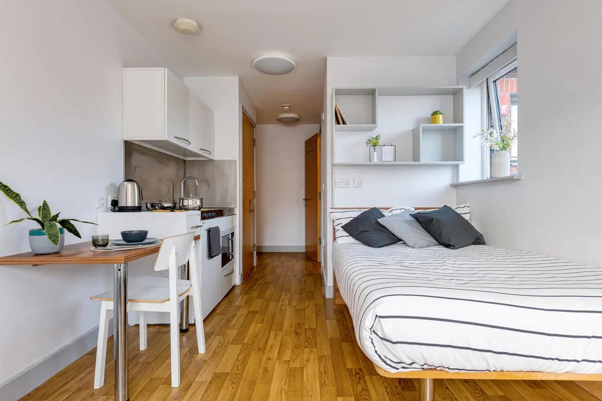 Bed table kitchen and study area studio apartment at Collegiate Earlsdon Street in Portsmouth Student Accommodation