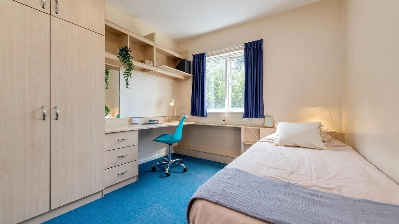 Wardrobe desk chair bed window bedroom at Collegiate Upper Quay House in Gloucester Student Accommodation