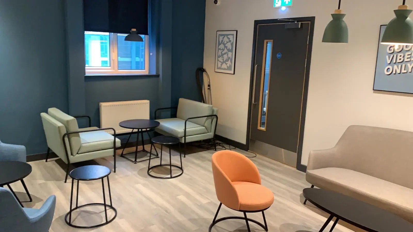 Seating tables and artwork in common area lounge at AXO Sherbourne Student Village in Coventry Student Accommodation