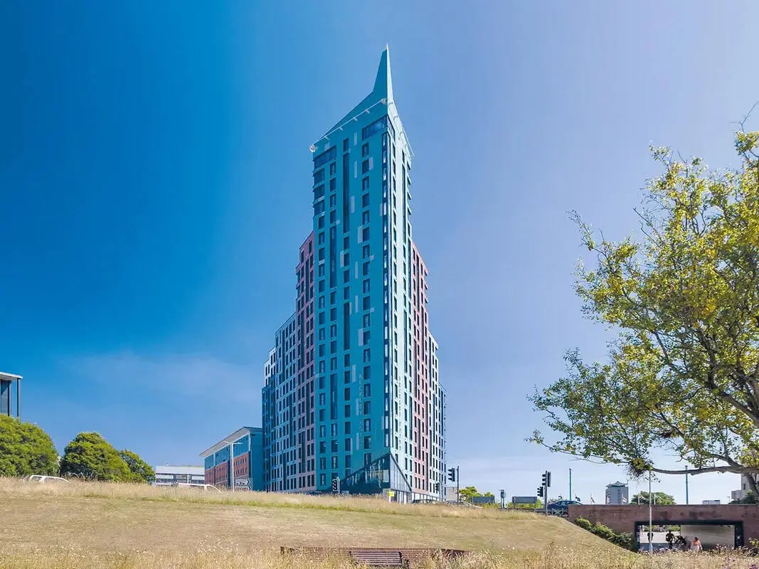 Modern blue high-rise building with windows exterior at Yugo Beckley Point in Plymouth Student Accommodation