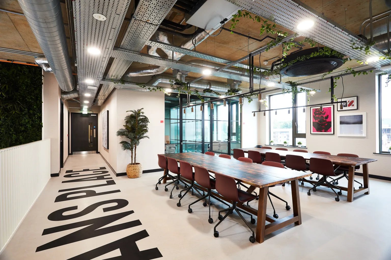 Communal tables with chairs and artwork Living room at Vita Student St.Albans in Leeds Student Accommodation