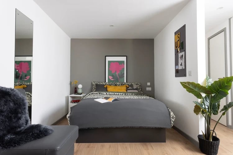 Bed with grey duvet and colourful pillows Bedroom at St Vincents Place in Sheffield Student Accommodation