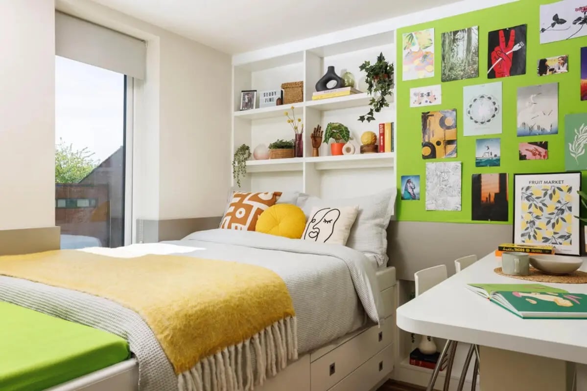 Bed with yellow blanket and desk bedroom at Quay Point Studios in Newcastle Upon Tyne Student Accommodation