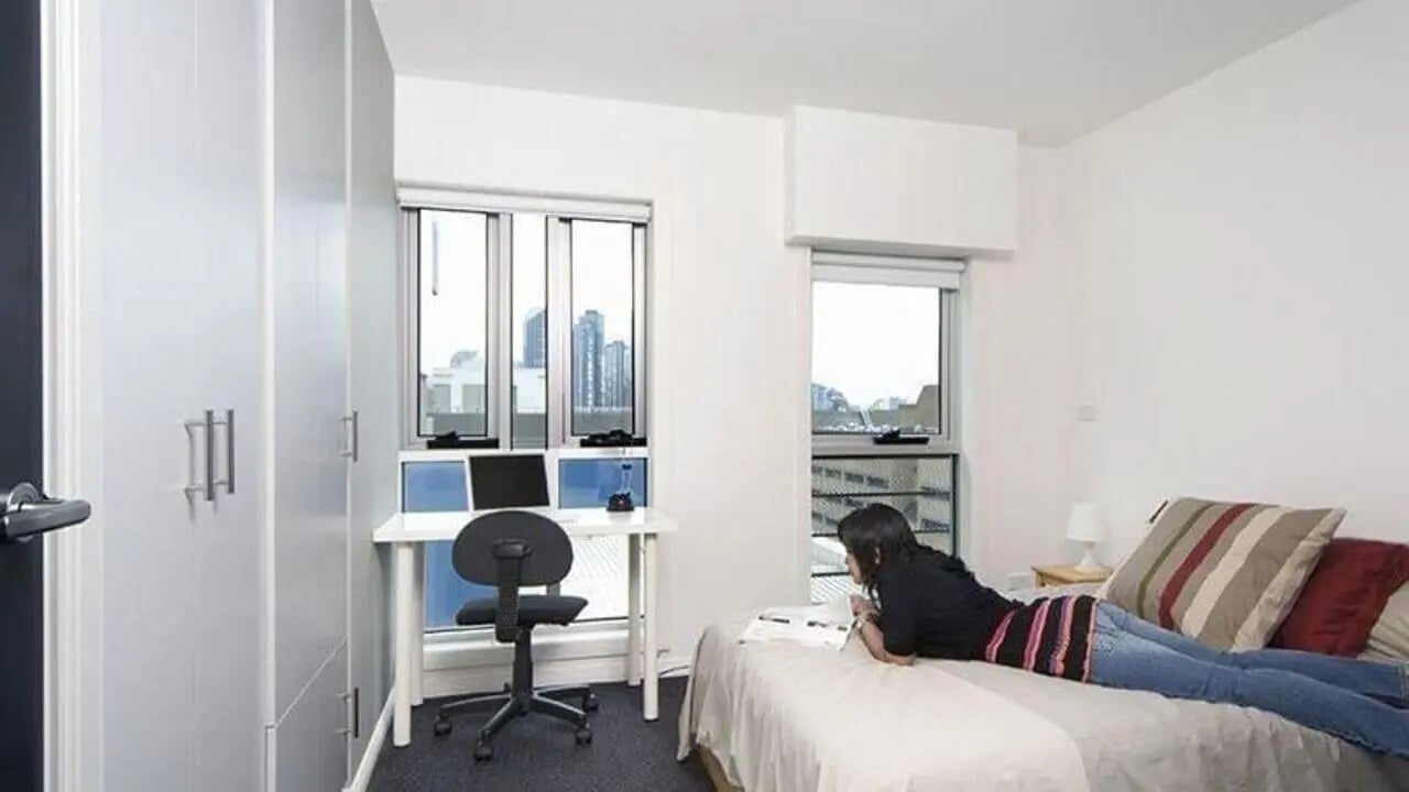 Desk bed laptop and wardrobe bedroom at Student Living - 740 Swanston in Melbourne Student Accommodation