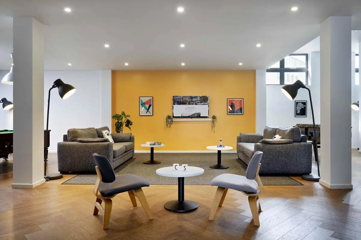Two sofas coffee tables chairs lamps living room at Discovery Heights in Plymouth Student Accommodation