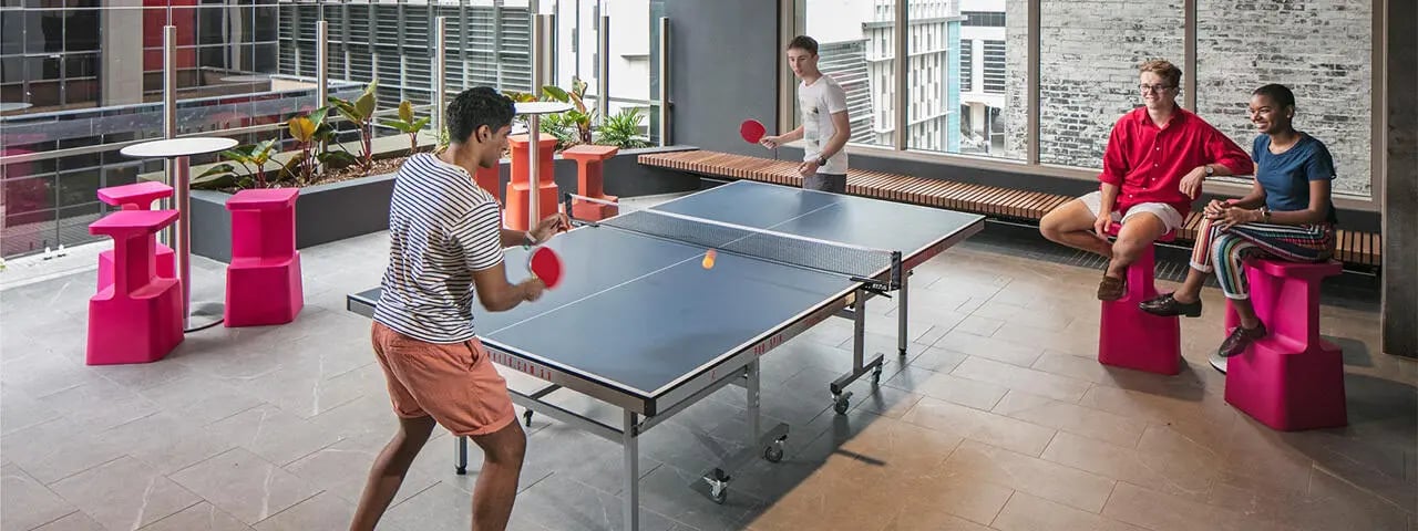 Ping pong table with students playing and watching playing area at Student One Wharf Street in Brisbane Student Accommodation
