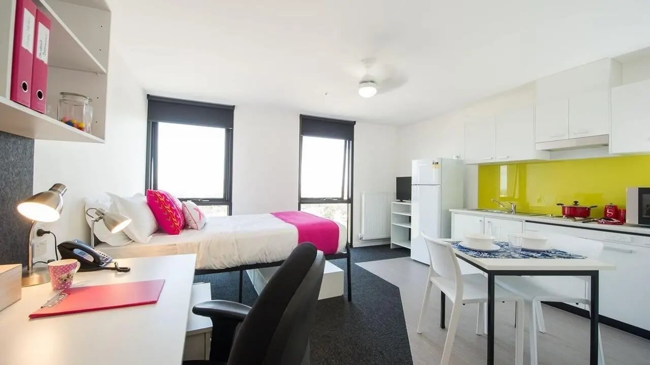 Bed desk kitchen and dining area studio at UniLodge Victoria University in Melbourne Student Accommodation