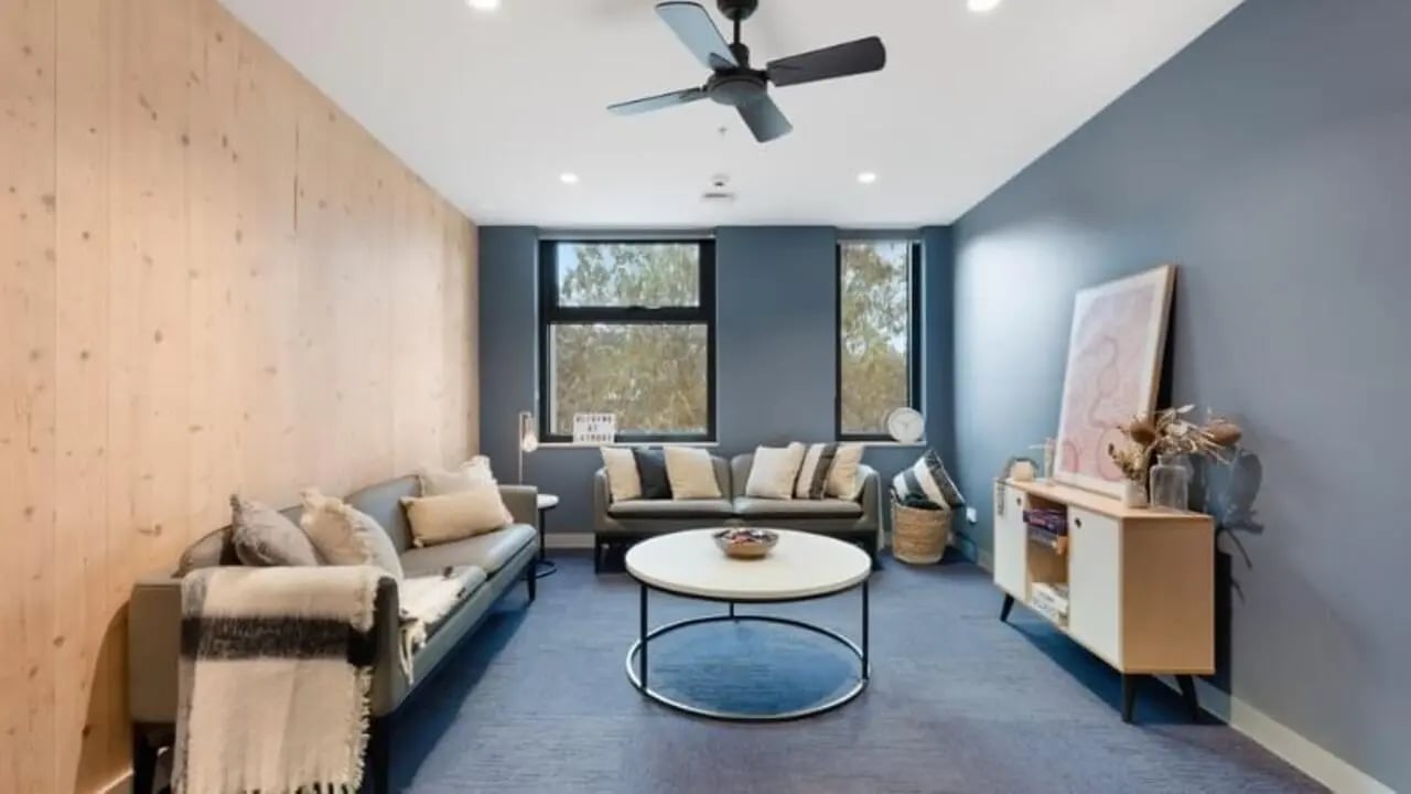 Sofas coffee table and artwork living room at La Trobe University - North and South Apartments in Melbourne Student Accommodation