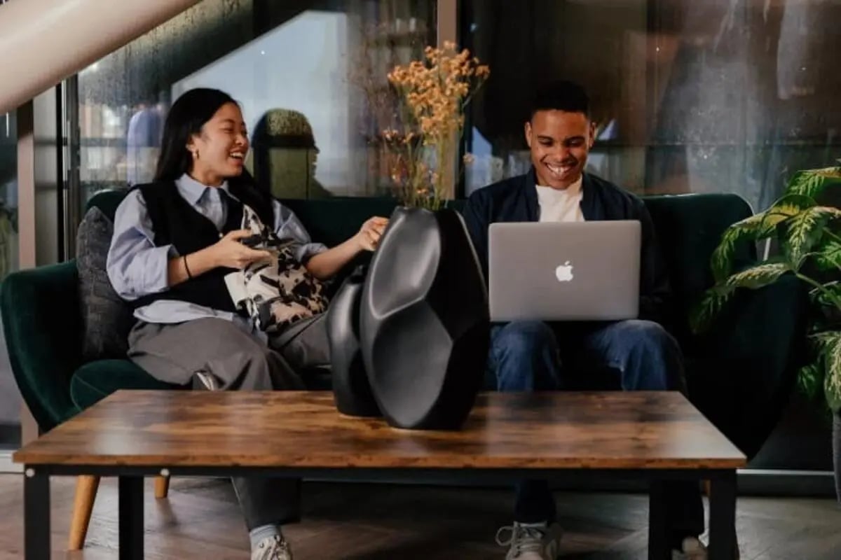 Two people on sofa with laptop living room at The Stay Club North Acton in London Student Accommodation