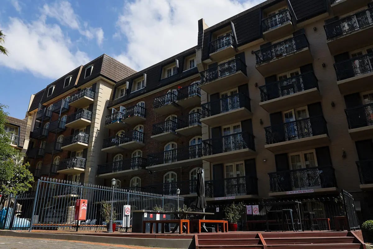 Balconied apartment building with outdoor seating area exterior at dwell Village Melbourne City in Melbourne Student Accommodation
