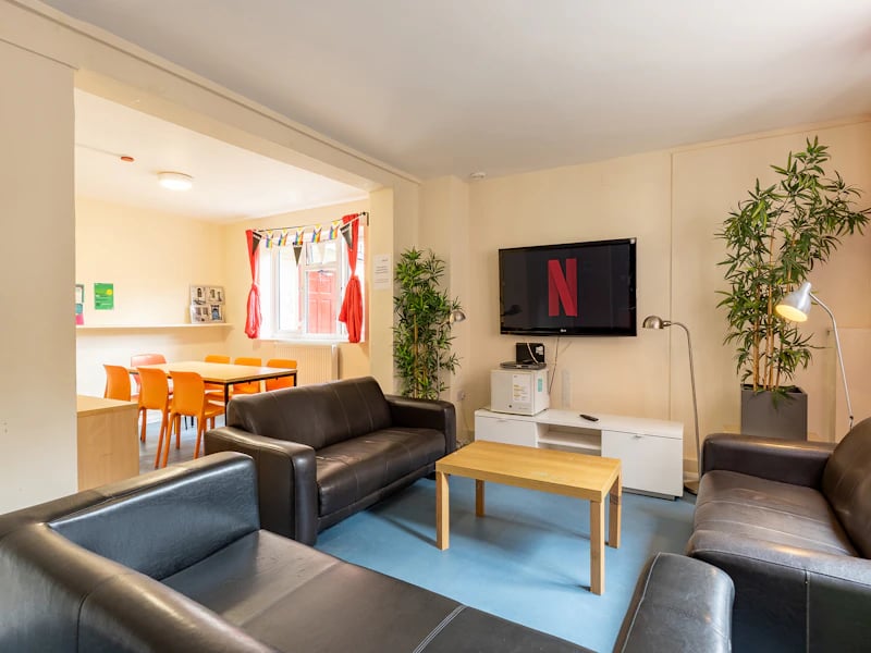 Leather sofas coffee table Netflix TV dining area living room at Brooke Hall in London Student Accommodation