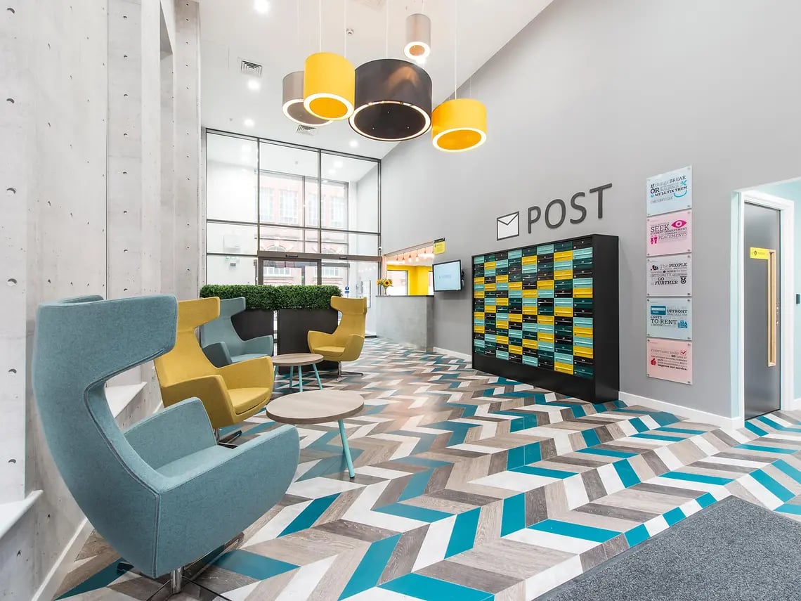 Colorful chairs mailboxes and floor pattern communal area at Yugo Bentley House in Birmingham Student Accommodation