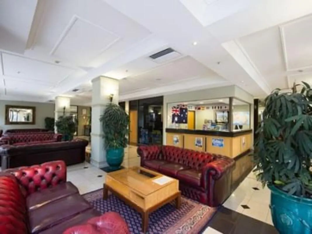 Chesterfield sofas reception desk plants lounge area at Student Living - Shafston in Brisbane Student Accommodation