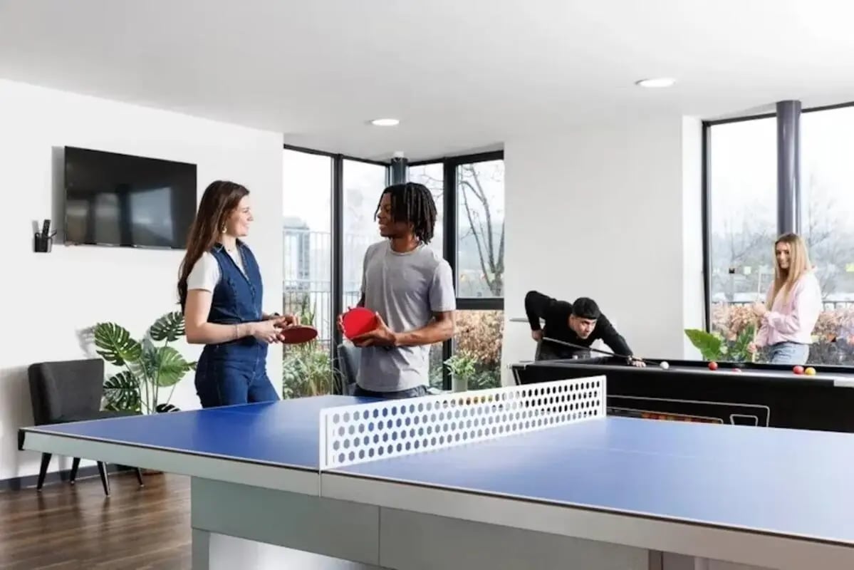 Ping pong table people playing pool recreation area at The Anvil in Sheffield Student Accommodation
