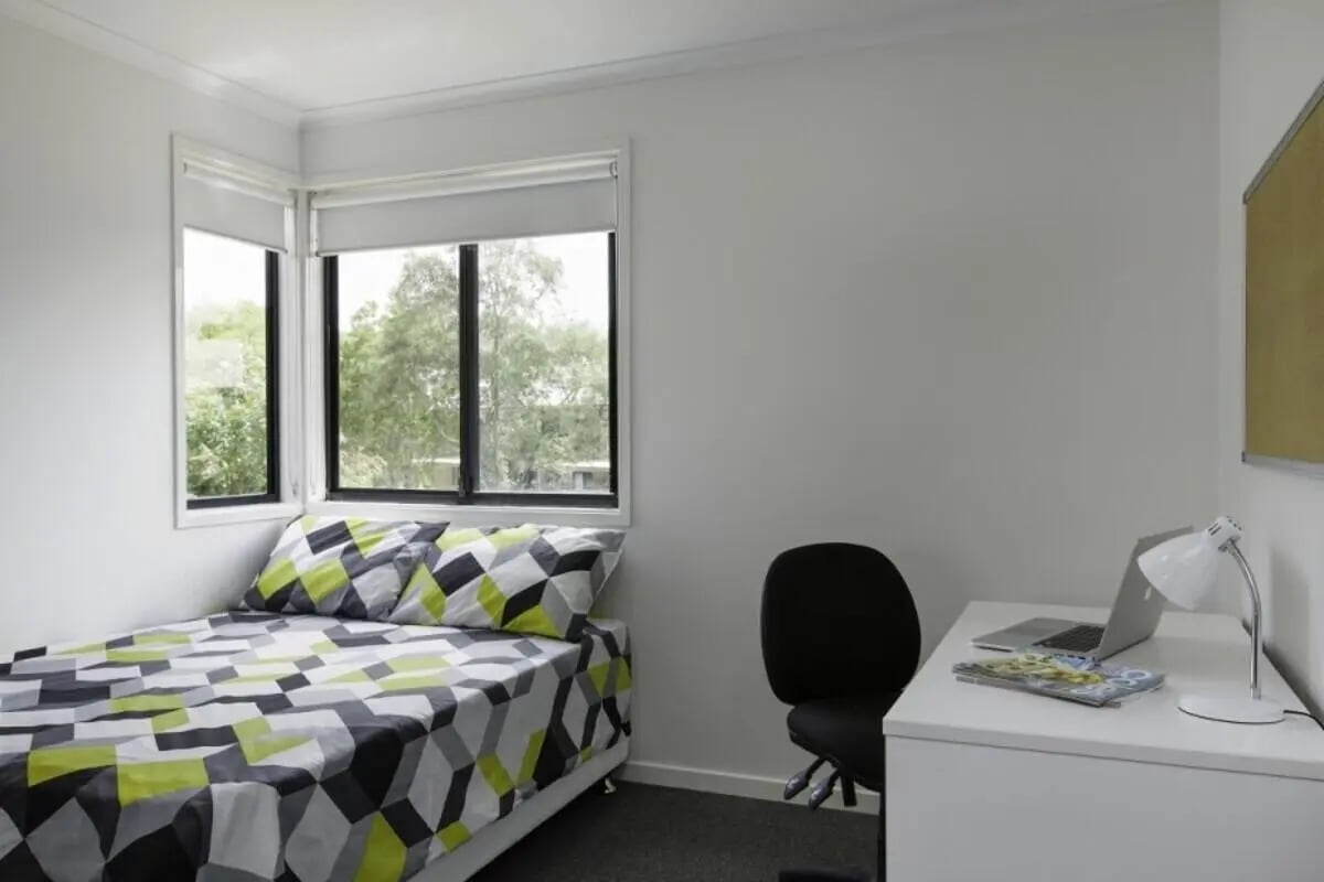 Bed desk laptop chair windows bedroom at Student Village North Ryde in Sydney Student Accommodation