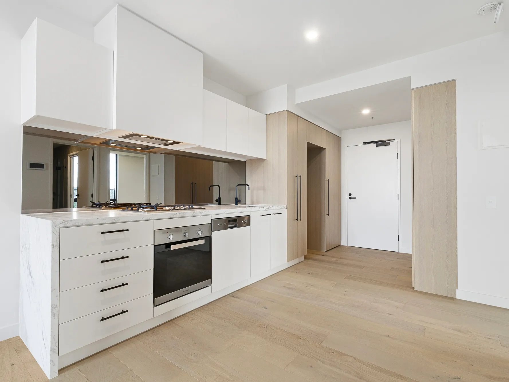 Modern kitchen with white cabinets stove and oven kitchen at BELONG Clayton Melbourne in Melbourne Student Accommodation