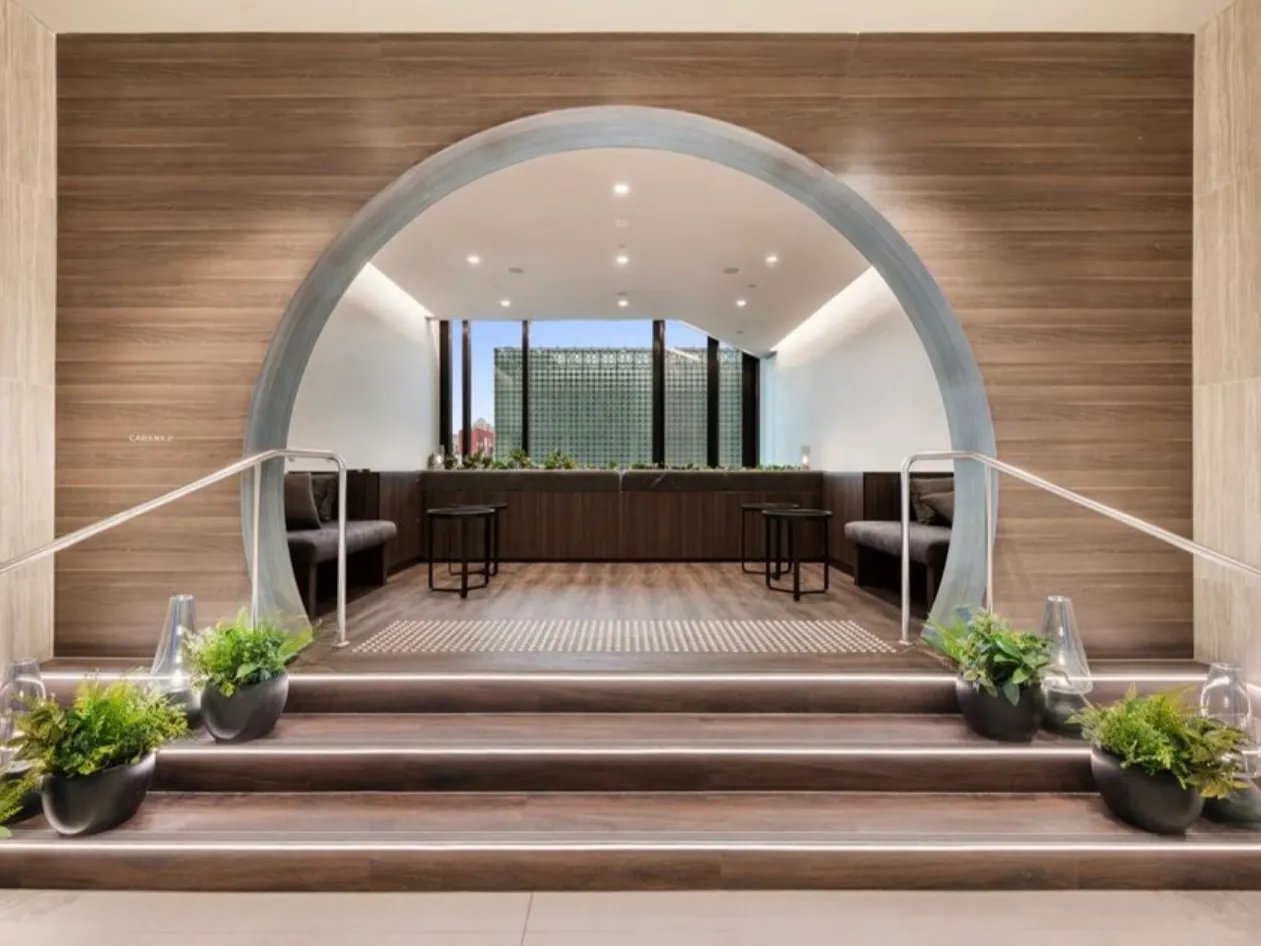 Seating benches tables plants stairwell entryway at Belong Melbourne CBD in Melbourne Student Accommodation