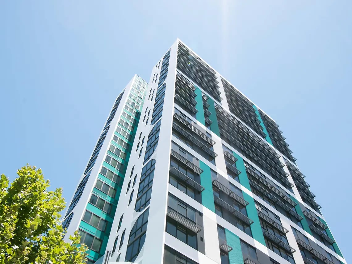 Modern apartment building with teal accents exterior at Yugo Perth City in Perth Student Accommodation