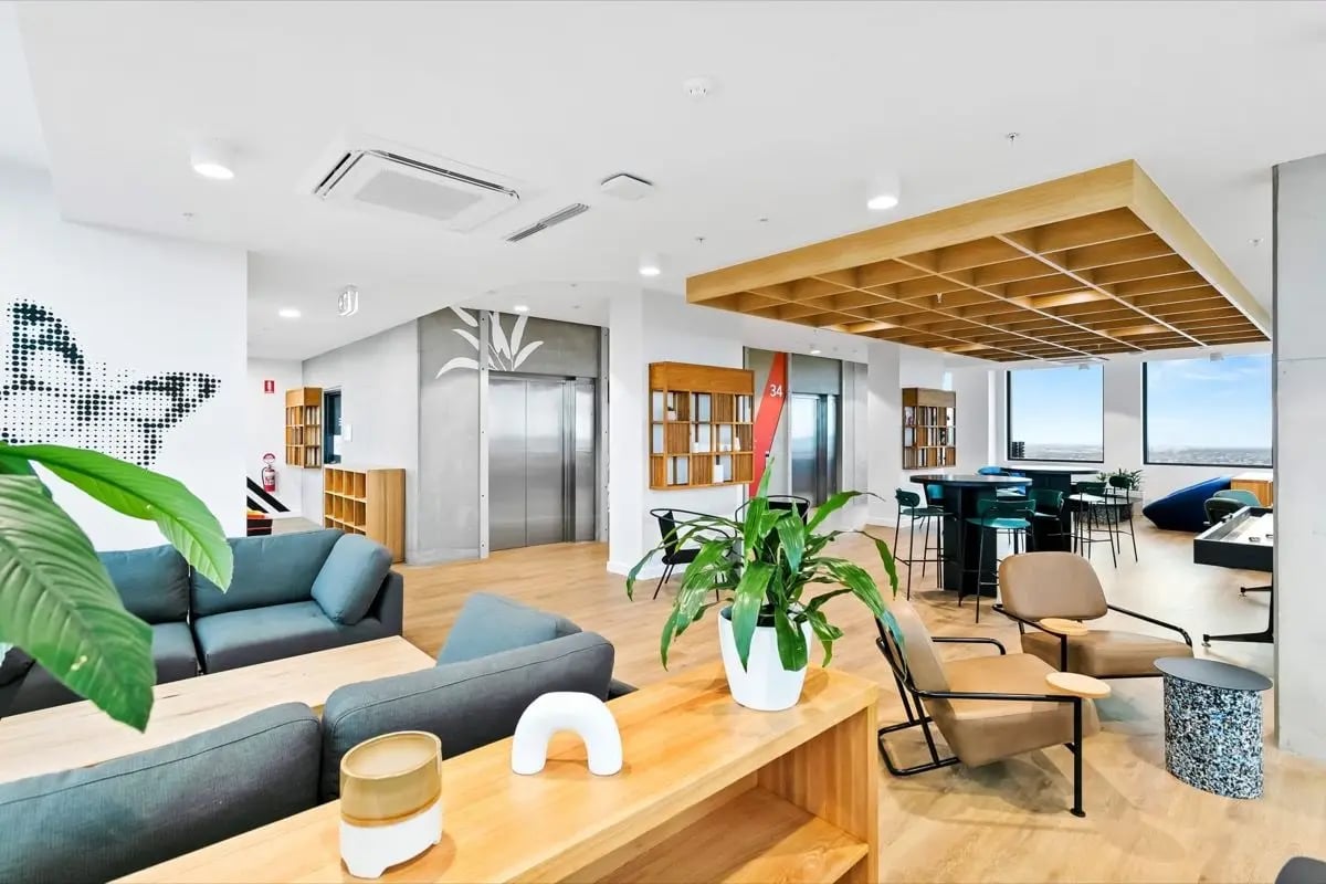 Modern lounge area with sofas chairs and study tables living room at The Switch Adelaide in Adelaide Student Accommodation