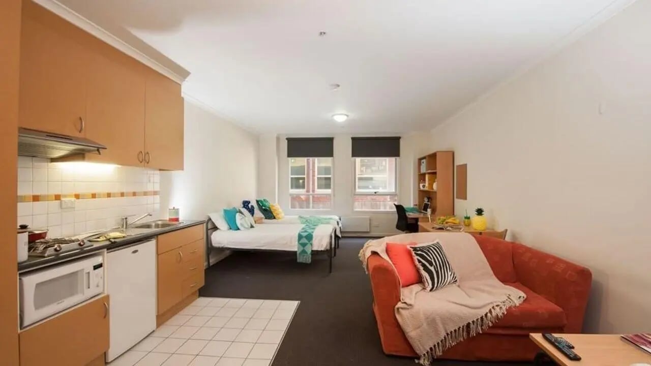 Kitchen beds desk couch study area apartment at Student Living on Flinders in Melbourne Student Accommodation