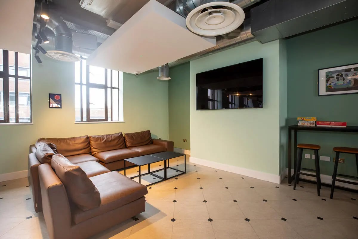 Brown sectional sofa black coffee table living room at Collegiate Nova in Nottingham Student Accommodation