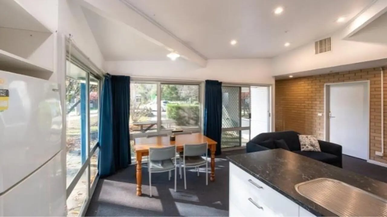Fridge dining table sofa and kitchen living area at UniLodge Wodonga East End in Wodonga Student Accommodation