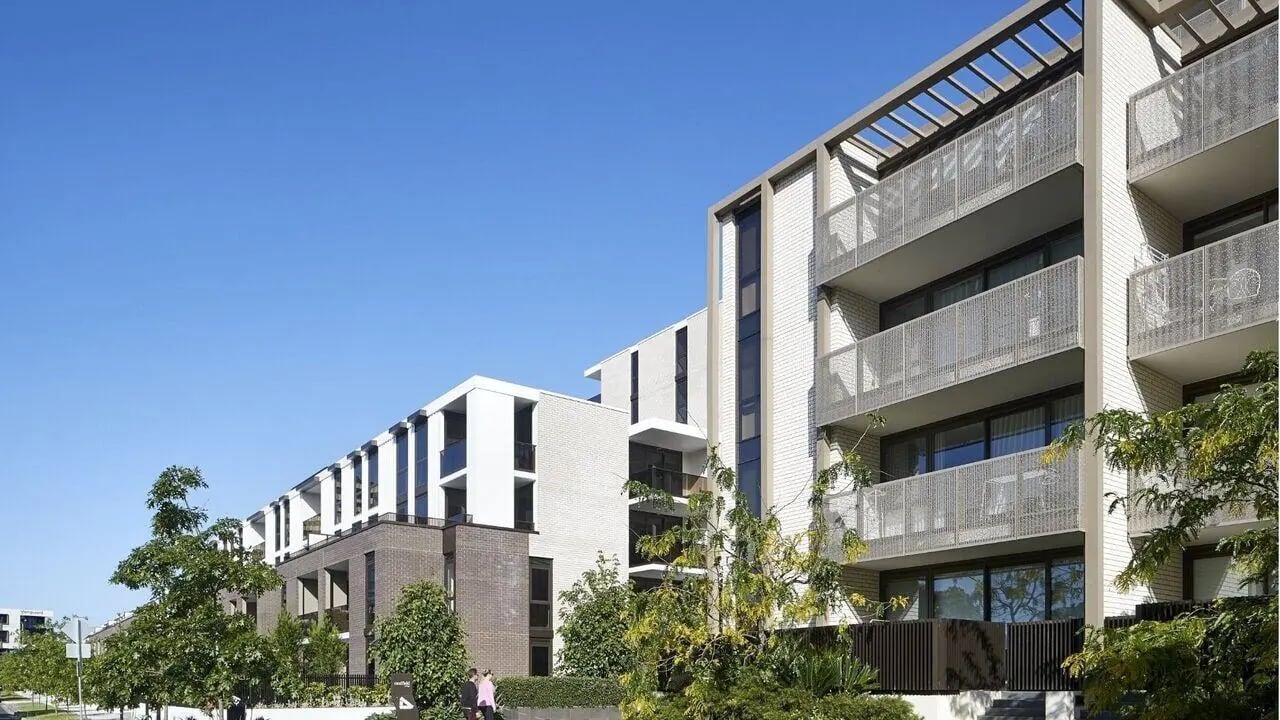 Modern apartment building with balconies and trees exterior at Realm Caulfield in Melbourne Student Accommodation