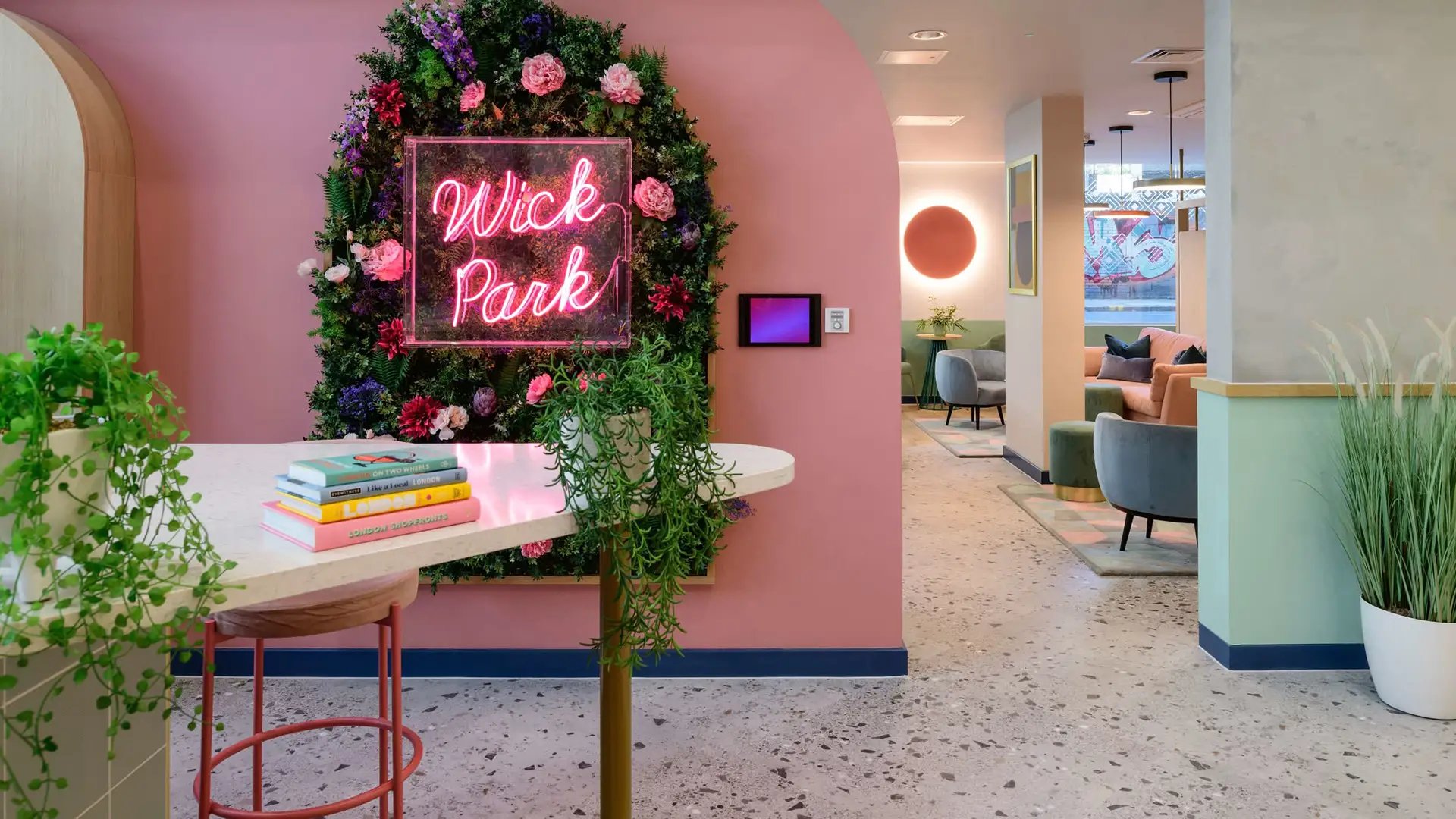 Floral wall Wick Park sign and seating area lounge at Wick Park in London Student Accommodation